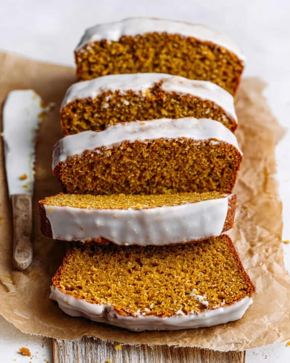The image shows five slices of orange-brown pumpkin bread with a light white glaze on top. The slices are stacked neatly on brown parchment paper, with the glaze shining slightly on the top of each slice. The texture of the bread looks soft and moist, with small bits of pumpkin or spices visible inside. A white knife with some crumbs lies next to the bread on the left. The background is a white marbled texture photo taken with an iphone --ar 4:5 --v 7