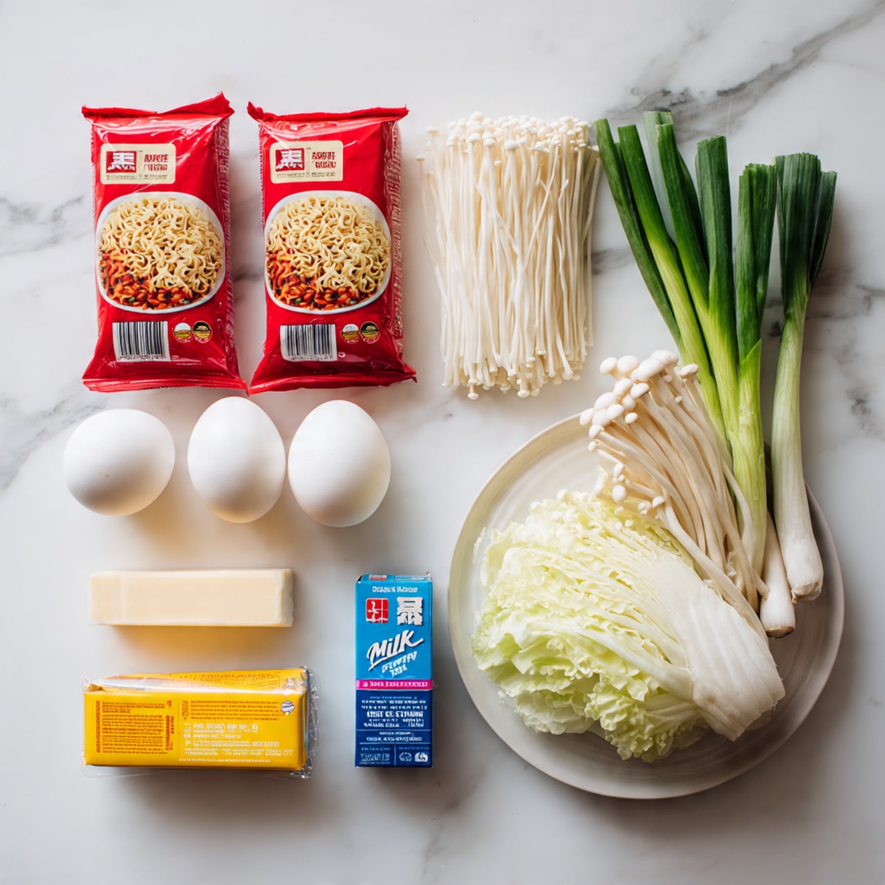 The image shows ingredients arranged neatly on a white marbled surface. On the left, there are two red packages of spicy chicken ramen noodles. In front of them, two eggs rest side by side. To the right, a white plate holds fresh vegetables including pale yellow cabbage, white enoki mushrooms with long thin stems, and green scallions. Below the plate are two rectangular yellow packages of processed cheese and a blue box of milk powder. The overall scene is bright, clean, and organized, emphasizing the ingredients for a homemade ramen meal. photo taken with an iphone --ar 4:5 --v 7