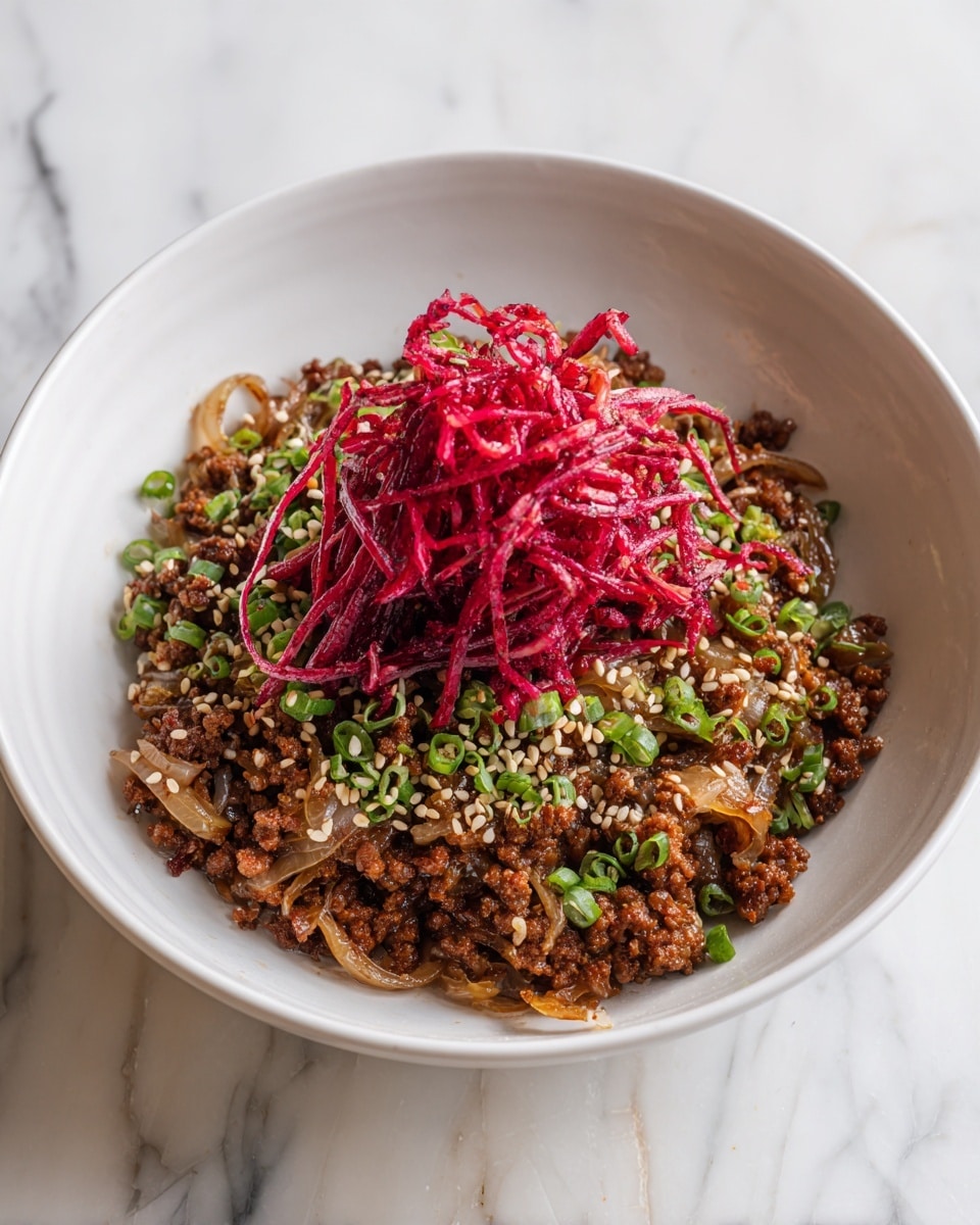 A white bowl holds a dish with three main layers; at the bottom is a layer of cooked brown meat, topped with caramelized translucent onion slices mixed in the meat. On top of the onions and meat, there is a pile of thin, bright reddish-pink strips placed in the center, surrounded by scattered small chopped green onions and light beige sesame seeds. The bowl sits on a white marbled surface. photo taken with an iphone --ar 4:5 --v 7