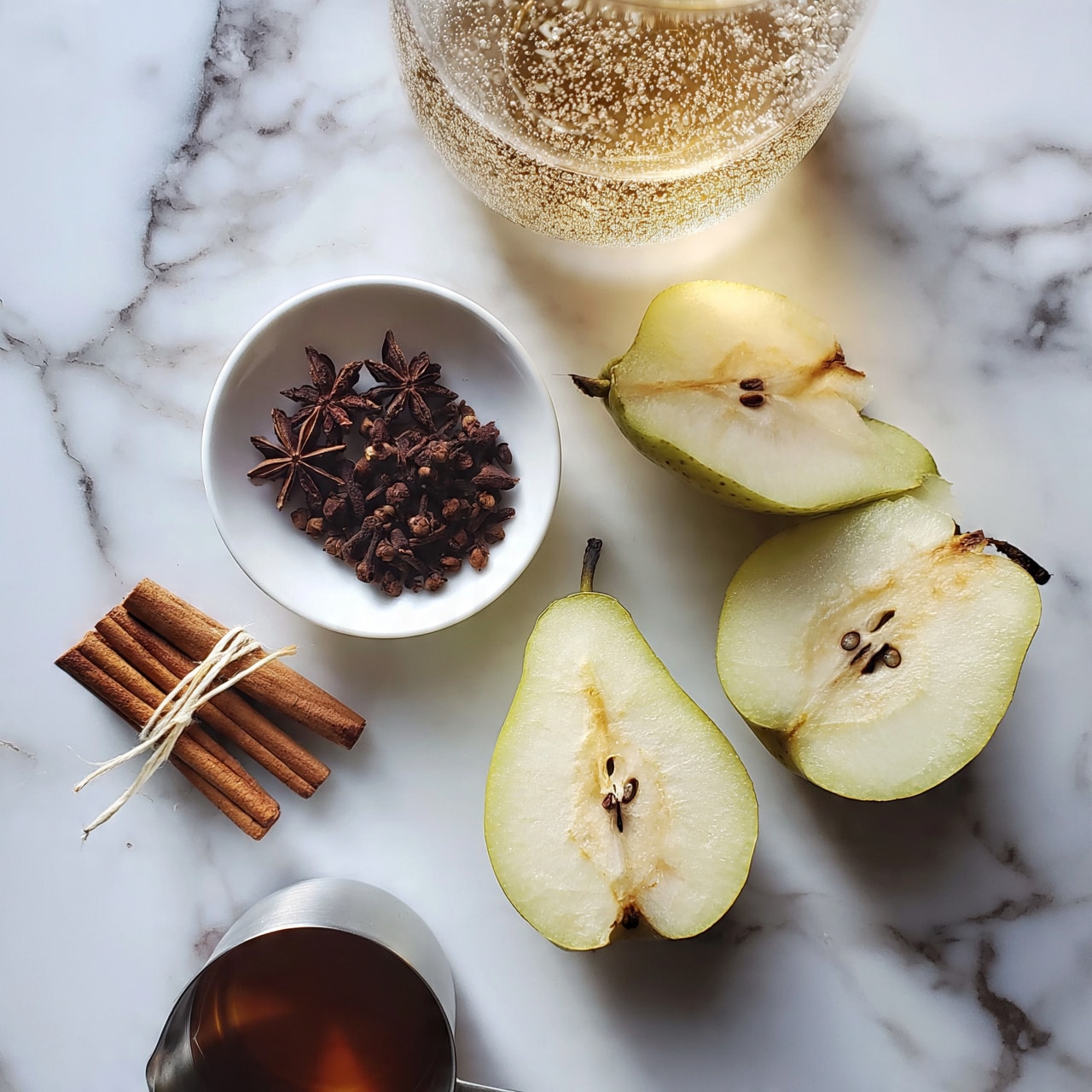 square image On a white marbled surface, there are three pear halves with light green skin and pale yellow inside, each showing the seeds and core. Near the pears is a small white bowl filled with dark brown whole spices including star anise and cloves. To the left of the bowl, a small bundle of cinnamon sticks tied with a light string lies flat. Below the cinnamon sticks, a metal measuring cup holds a dark amber liquid. Above the pears and bowl, a clear glass container shows a light golden bubbly liquid. Photo taken with an iphone --ar 4:5 --v 7