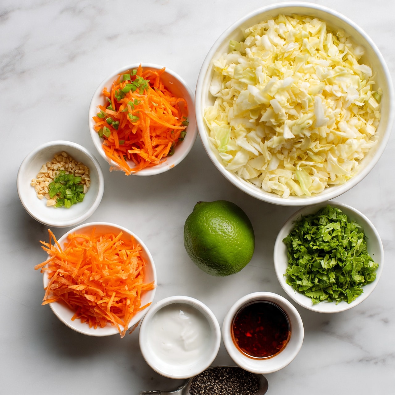 square image The image shows several small white bowls and one white large bowl arranged on a white marbled surface. The largest white bowl at the top right is filled with chopped pale yellow cabbage. Surrounding it clockwise are a white bowl with thin shredded bright orange carrots, a white bowl with small green pieces of chopped herbs or scallions, a white bowl with small light brown crushed nuts or seeds, a white bowl with bright green chopped fresh herbs, a small white bowl with white sauce, and another small white bowl with dark red-brown liquid, likely a sauce. A whole bright green lime is also present near the center. There is a spoon with some coarse black pepper or seeds near the bottom. The colors are fresh and vibrant, with a neat and clean appearance. Photo taken with an iphone --ar 4:5 --v 7