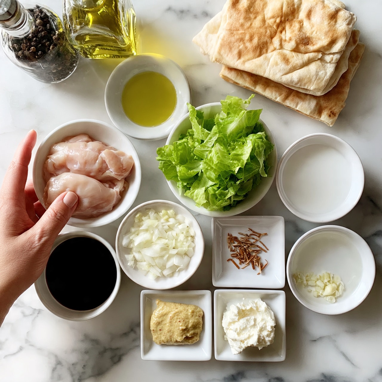 square image The image shows various ingredients for cooking arranged neatly on a white marbled surface. There are two pieces of light golden flatbread stacked on the top right. To the left are two glass bottles, one with dark pepper and the other with yellow olive oil. Below them is a small white bowl with two raw, pale pink chicken pieces. Next to the chicken is a small white bowl filled with chopped bright green lettuce. To the right of the lettuce is a small white bowl with white liquid sauce. Below these bowls, from left to right, are a small white bowl with dark soy sauce, a small white bowl of finely chopped white onions, a small white bowl with small brown dried sticks, a small white square dish with light yellow mustard, a small white square dish with white chunky butter, a small white bowl with clear liquid, and a small white dish with small minced white garlic pieces. A woman's hand is carefully reaching towards the ingredients on the left side. Photo taken with an iphone --ar 4:5 --v 7