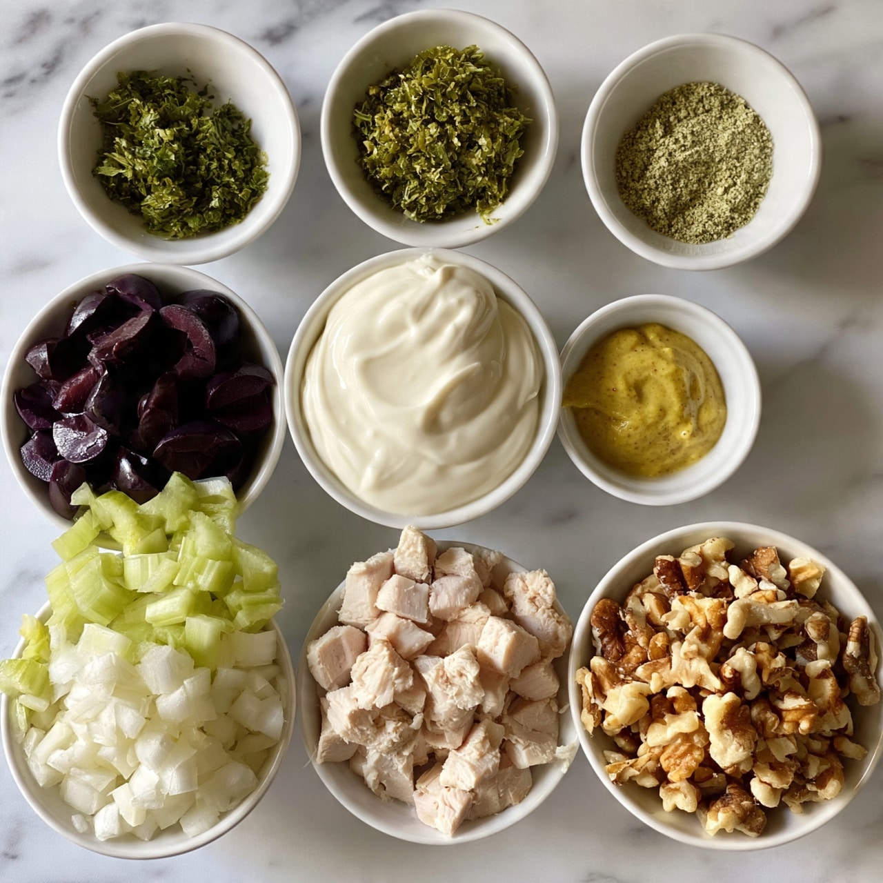 square image The image shows nine small white bowls arranged on a white marbled surface, each filled with different ingredients for a recipe. Starting from the top, the first bowl contains chopped green herbs, and next to it is a small bowl with a fine greenish powder, likely a spice. Below them is a bowl filled with a thick, creamy white sauce, and next to it, a tiny bowl with a golden-yellow mustard-like sauce. To the left side, one bowl holds dark purple sliced olives, while below that another bowl is filled with chopped light green celery. Next, there is a bowl with finely diced white onions, and another bowl filled with diced light pink cooked chicken. The last bowl contains rough chopped walnuts with a brown and tan texture. The bowls are neatly placed and the colors create a fresh and organized look. Photo taken with an iphone --ar 4:5 --v 7