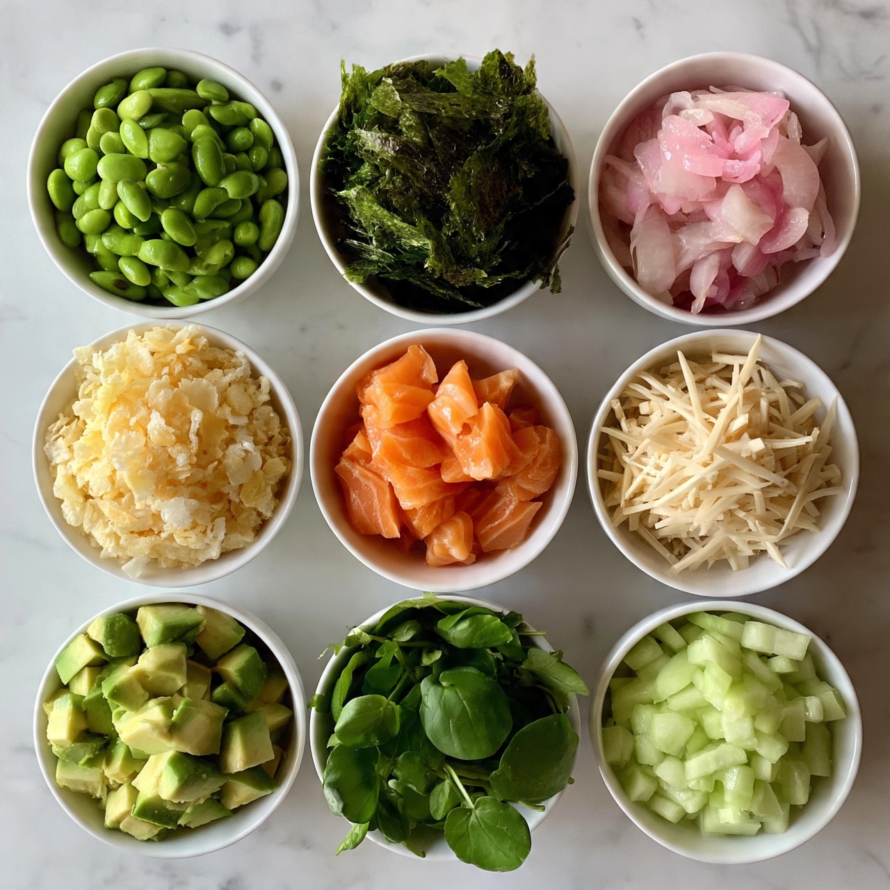 square image Nine white bowls are arranged in a 3x3 grid on a white marbled surface. The top row has bright green edamame in the left bowl, dark green seaweed sheets with a rough texture in the middle bowl, and light pink pickled onions with a soft look in the right bowl. The middle row shows pale yellow crunchy tempura flakes on the left, orange salmon chunks with a smooth texture in the center, and off-white thin bamboo shoots with fine texture on the right. The bottom row contains light green diced avocado in the left bowl, deep green round watercress leaves in the middle, and pale green diced cucumber with a fresh look in the right bowl. Photo taken with an iphone --ar 4:5 --v 7