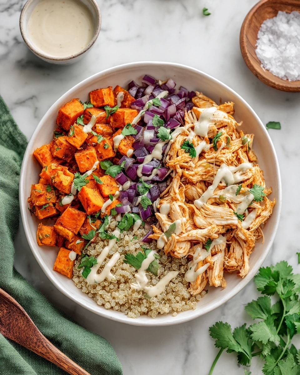 The image shows a white bowl filled with three main layers arranged side by side. On the left side, there are small pieces of roasted orange sweet potatoes garnished with a few green cilantro leaves. In the middle, there are chopped purple-red onions providing a fresh contrast. On the right side, there is a serving of shredded light orange chicken with white sauce drizzled over it. At the bottom under the chicken, a light beige grain, likely quinoa, is visible. The bowl sits on a white marbled surface with a green cloth and a light brown wooden chopstick on the left side, and some fresh cilantro leaves on the lower right corner. In the background, there is a small white bowl of sauce and a wooden bowl of coarse salt photo taken with an iphone --ar 4:5 --v 7