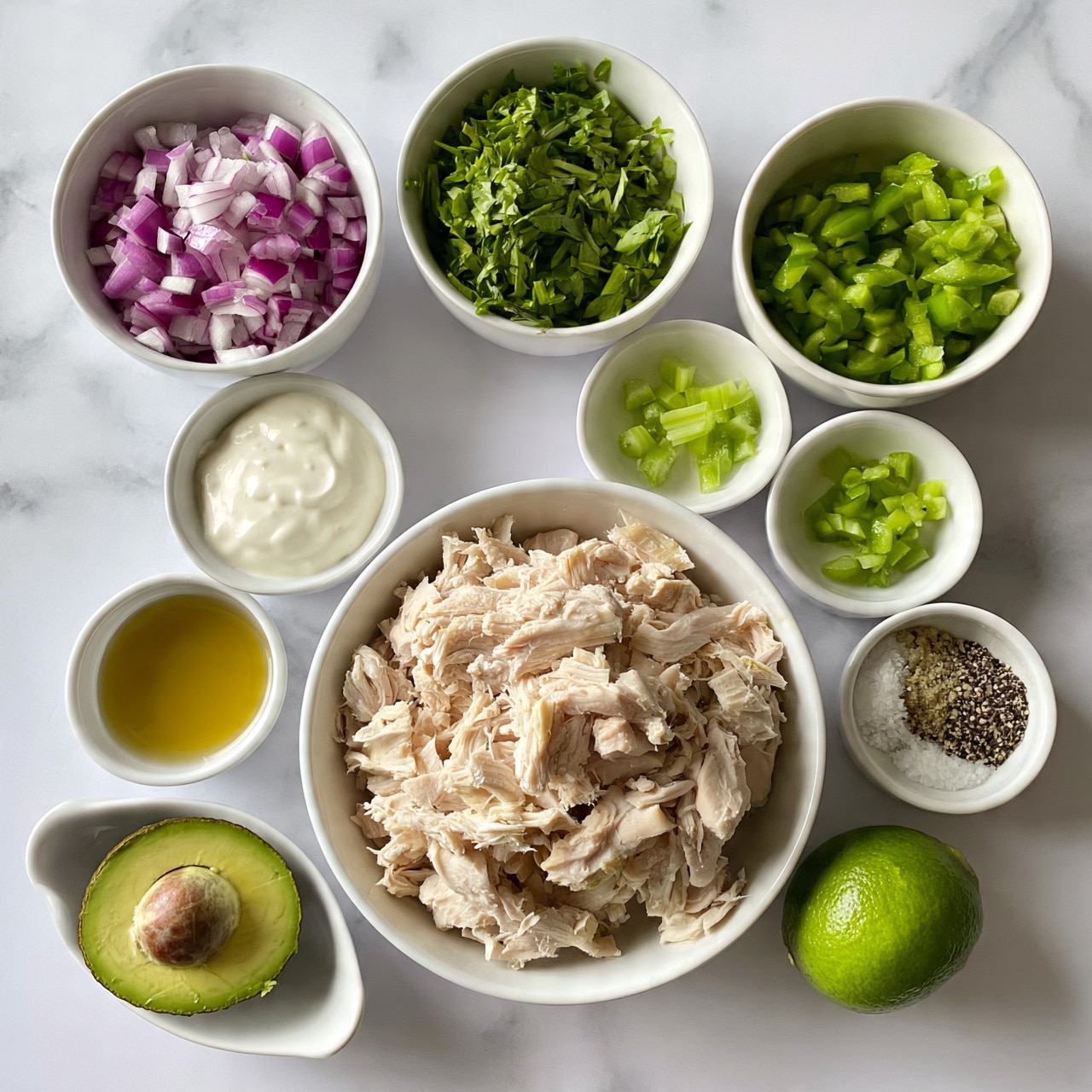 square image The image shows multiple white bowls arranged neatly on a white marbled surface, each with different ingredients. There is a larger bowl filled with shredded chicken that looks tender and light beige in color. Surrounding it are smaller bowls holding diced red onions with a deep purple tone, freshly chopped green herbs, chopped green bell peppers, a creamy white sauce, and small green celery pieces. Another bowl contains a golden-yellow liquid, possibly oil, and a small bowl holds a mix of salt, black pepper, and other spices. A white dish holds half an avocado with a visible seed and another dish contains a whole bright green lime. All the items are clean and fresh, arranged thoughtfully to show each ingredient clearly. Photo taken with an iphone --ar 4:5 --v 7