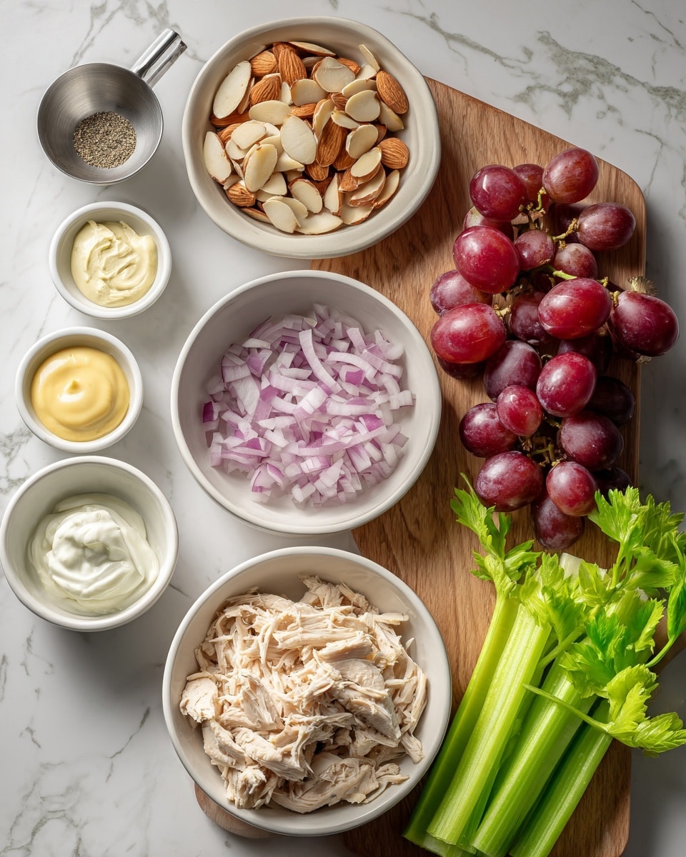 The image shows a top view of ingredients arranged neatly on a white marbled surface. There are eight white bowls and a wooden board. On the bottom right, a round white bowl is filled with shredded white chicken meat. To the left of it, a small white bowl holds finely chopped red onions. Above them, a medium white bowl contains sliced almonds with their inside cream and edges brown. Between the top two bowls, three small white containers hold creamy sauce (yellow mustard), mayonnaise, and a salt and pepper mix. A small metal measuring cup with a white creamy ingredient sits near the left edge. On the wooden board on the right side, a bunch of red grapes with smooth, shiny skin sits next to several bright green celery stalks with fresh leaves. photo taken with an iphone --ar 4:5 --v 7