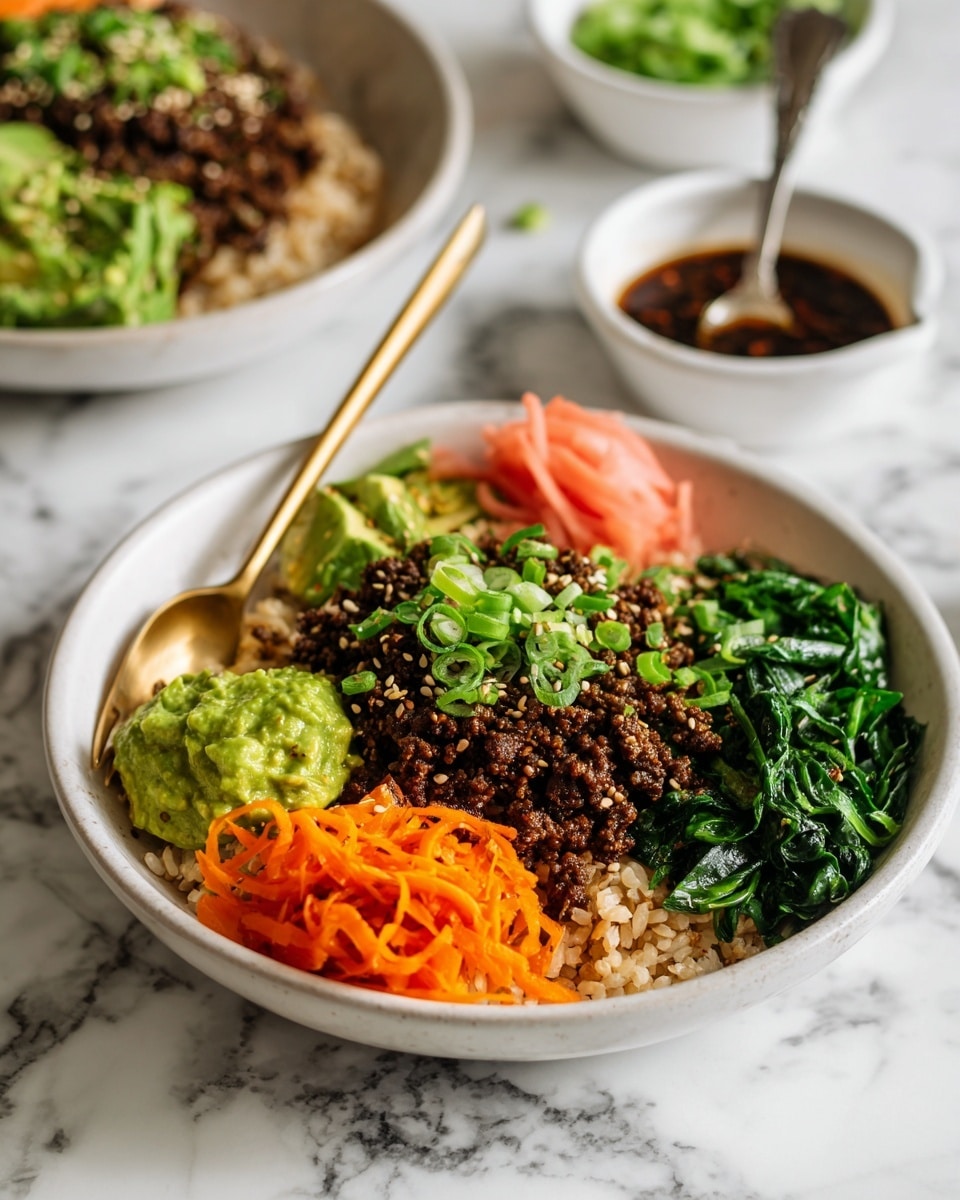 The image shows a white bowl filled with layers of food on a white marbled surface. The bottom layer is white rice, topped with a layer of cooked ground meat sprinkled with green onion slices and white sesame seeds. To one side, there is a heap of sautéed dark green spinach. On the opposite side, fresh green lettuce leaves hold a small pink piece of pickled ginger. Below the lettuce are bright orange shredded carrots, and next to them is a small dollop of light green mashed avocado. In the background, there is another bowl with similar food and a small white bowl with a dark, textured sauce and a spoon. A woman's hand holds a gold spoon inside the main bowl. Photo taken with an iphone --ar 4:5 --v 7