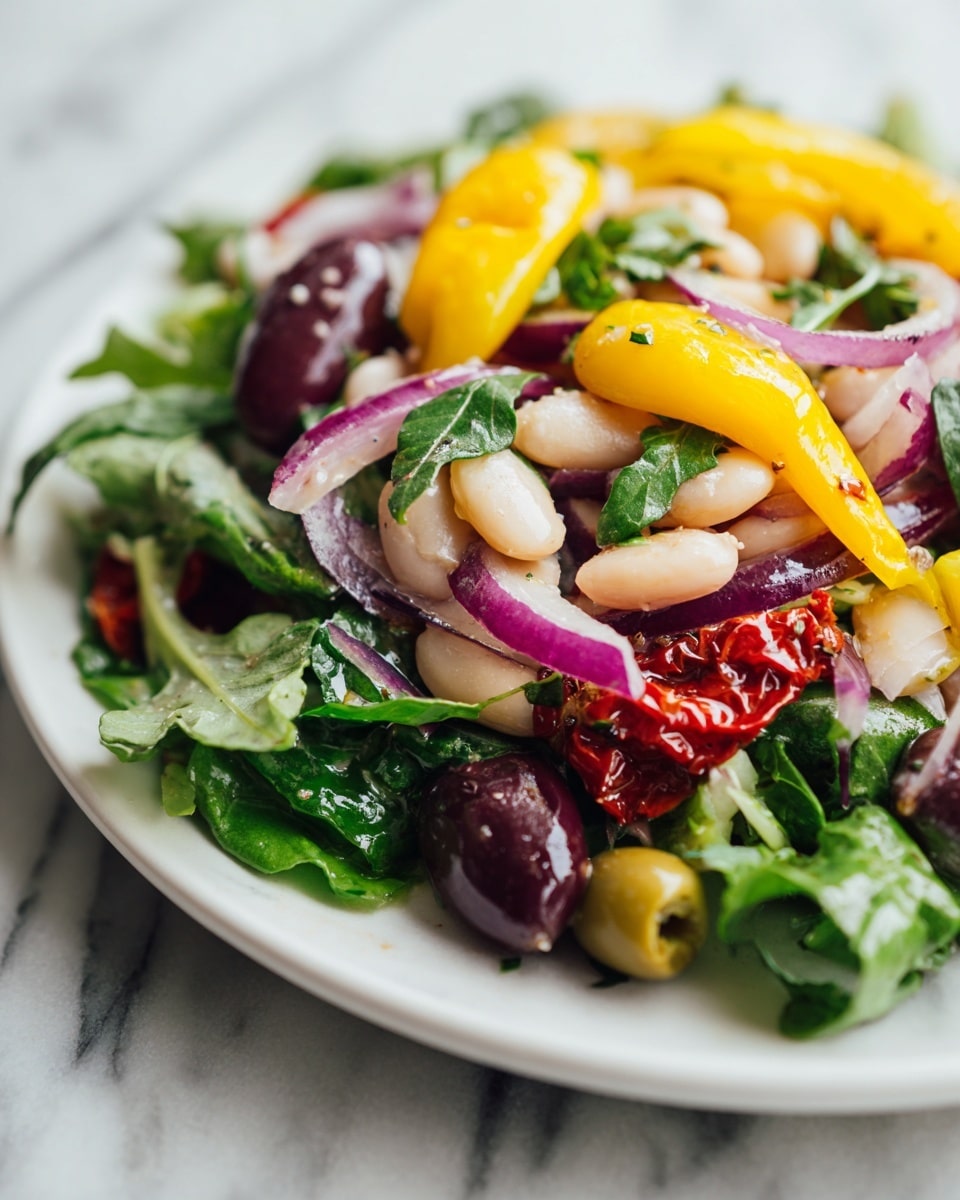 A close-up view of a white bowl filled with a colorful bean salad layered with white beans as the main texture. Mixed in are layers of green and dark red olives with a smooth, shiny texture. Bright yellow pickled peppers sit on top, adding a vibrant pop of color. Thin purple slices of red onion are spread throughout the salad, adding curves and a slight translucence. Small green herb leaves are scattered on the salad, giving a fresh look. Pieces of sun-dried tomatoes add a deeper red-brown color and a wrinkled texture. The bowl rests on a white marbled surface. photo taken with an iphone --ar 4:5 --v 7
