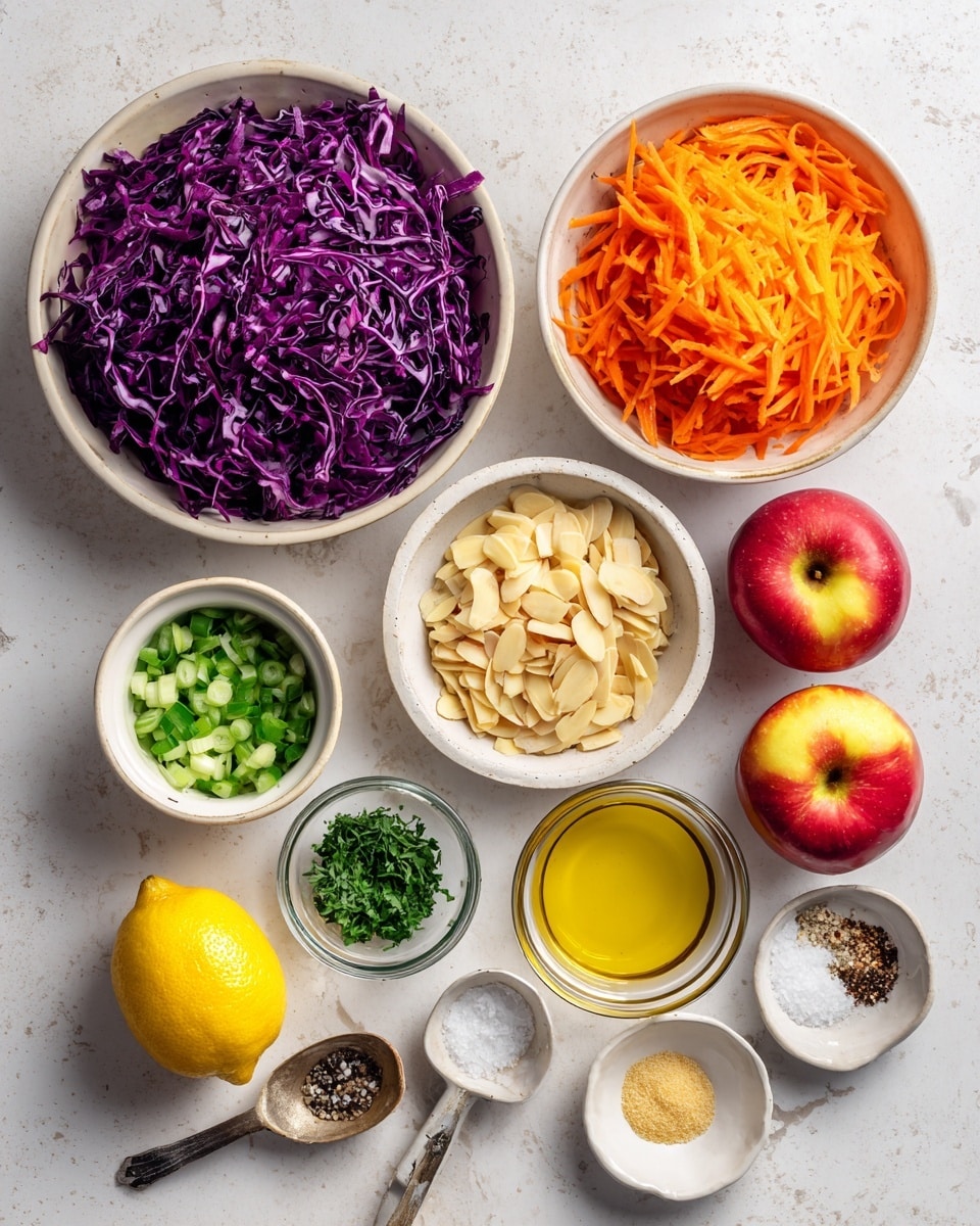 An overhead view of several ingredients laid out on a white marbled surface: a large white bowl filled with shredded deep purple cabbage at the top left, next to a white bowl with bright orange shredded carrots at the top right. Two red apples with yellow centers are placed below the carrots. Below the cabbage are smaller white bowls with chopped green onions and a creamy beige dressing. Nearby are a small glass bowl filled with light brown sliced almonds, a small white bowl with green chopped herbs, and a spoon with finely chopped garlic. At the bottom are a fresh yellow lemon, a spoon holding grainy mustard, a spoon with olive oil, and a small white dish with salt and black pepper. photo taken with an iphone --ar 4:5 --v 7