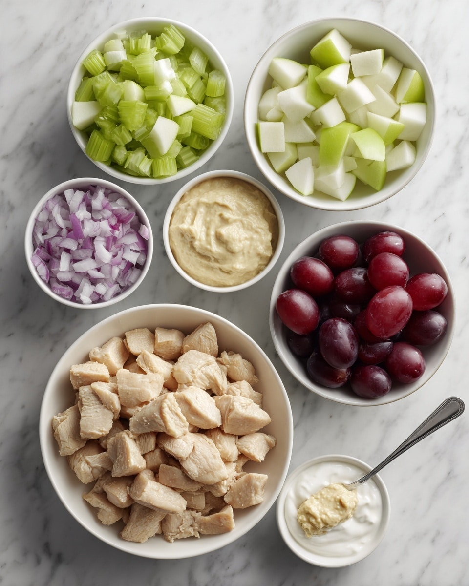 The image shows a flat lay of various food ingredients arranged on a white marbled surface. At the center bottom, there is a white bowl filled with light brown cooked chicken pieces. Surrounding it are five small white bowls: at the top left is chopped light green celery, at the top center is halved dark red grapes, at the top right is light green chopped apple, at the bottom left is finely chopped red onion, and at the bottom center-left is white creamy yogurt. To the right of the chicken bowl is a spoon with a pale yellow thick paste. The colors and textures are clear, with a clean and neat presentation. photo taken with an iphone --ar 4:5 --v 7