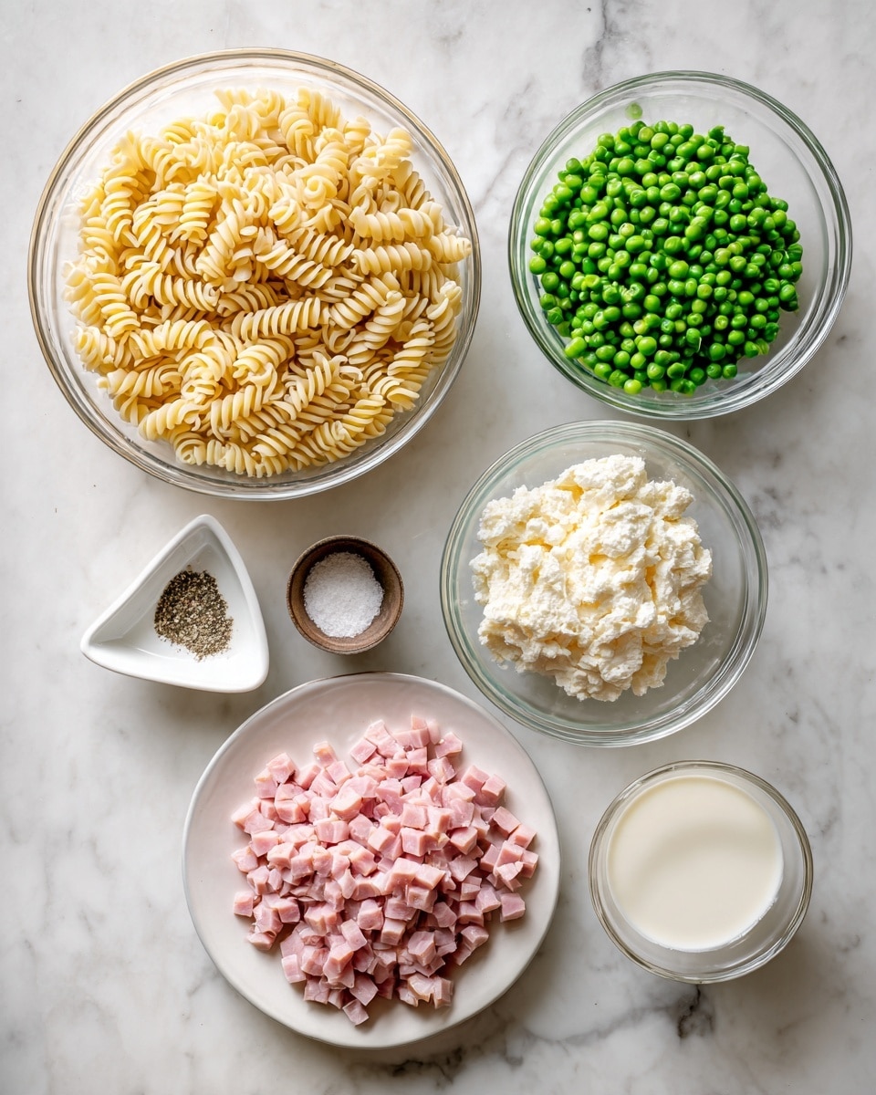 The image shows seven bowls arranged on a white marbled surface. On the top left is a large clear glass bowl filled with cooked spiral pasta, light yellow in color. To its right is another clear glass bowl full of bright green peas. Next to that on the far right is a clear glass bowl holding a white creamy mixture. Below, in the bottom right, there is a white plate heaped with small pink diced pieces of ham. To the left of the ham, there are three small bowls: a white triangular bowl with some black pepper and salt, a small mocha cup with a white powder (likely seasoning), and a small clear glass bowl containing white liquid, probably milk or cream. The whole setup sits neatly on the white marbled surface, giving a clean and organized look. Photo taken with an iphone --ar 4:5 --v 7