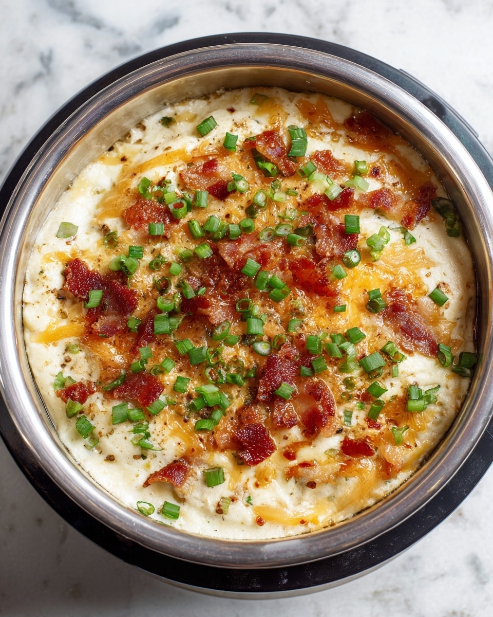 A round single-layer dish inside a silver metal inner pot with a black outer lid, filled with a creamy white base topped with shredded orange and white cheese, sprinkled with small pieces of crispy brown bacon, and scattered with chopped fresh green onions all over. The background is a white marbled texture photo taken with an iphone --ar 4:5 --v 7