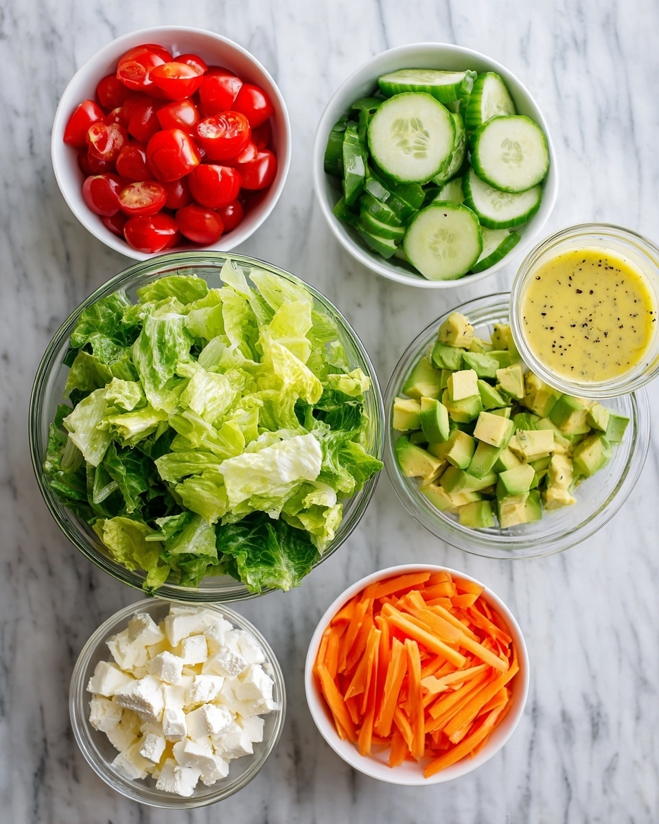 The image shows six white bowls placed on a white marbled texture. In the center is a large clear glass bowl filled with green leafy lettuce. Above it, to the left, is a bowl of bright red halved cherry tomatoes, and to the right, a bowl with green cucumber slices. On the right side, there is a small glass container with light yellow salad dressing that has black specks in it. Below the dressing, a white bowl is filled with diced green avocado. To the left of the avocado, another white bowl contains white crumbly cheese. At the bottom center, a small clear glass bowl holds thin orange carrot strips. photo taken with an iphone --ar 4:5 --v 7