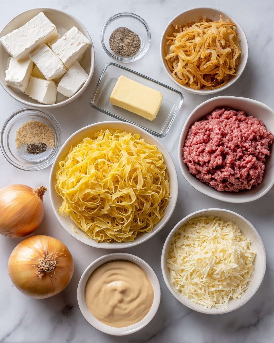 A top view of various cooking ingredients placed neatly on a white marbled surface. In the center is a white bowl filled with yellow dried egg noodles. Around it from left to right: a white bowl with white cream cheese blocks, a small clear bowl of light brown seasoning, a rectangular clear dish with a stick of pale yellow butter, a clear glass jar of black pepper, a white bowl full of golden brown fried onions, a whole yellow onion with its skin, a white bowl containing a thick beige sauce, a white bowl with shredded white cheese, and a white bowl with raw ground beef showing a mix of red and pink tones. photo taken with an iphone --ar 4:5 --v 7
