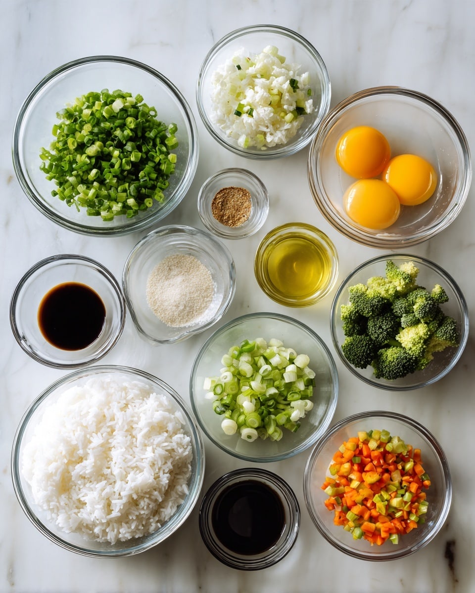 The image shows 11 clear glass bowls arranged neatly on a white marbled surface, holding different cooking ingredients. The largest bowl at the bottom left contains white cooked rice, while to its right, a medium bowl holds two raw eggs with bright yellow yolks visible. Above the eggs, several small bowls hold finely chopped fresh vegetables and sauces: diced green and orange mixed vegetables, chopped green onions, broccoli pieces, light green onion slices, minced garlic, a light yellow liquid, dark soy sauce, a darker vinegar-like sauce, and a small amount of ground beige spice. The bowls vary in size but are all transparent, showing the colors and textures of the ingredients clearly. photo taken with an iphone --ar 4:5 --v 7