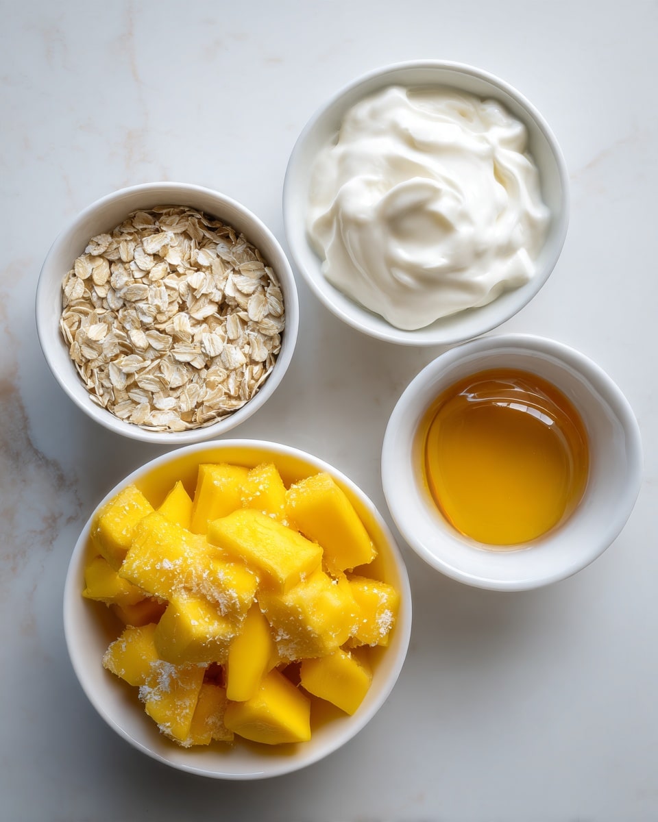 The image shows five white bowls placed on a white marbled surface. At the center bottom, there is a bowl filled with bright yellow frozen mango chunks, some covered with frosty ice crystals. Above it to the left is a small bowl filled with light beige rolled oats. To the top center is a bowl with thick, white yogurt with a smooth texture. To the right of this is a small bowl containing golden amber honey, glossy and smooth in appearance. Below the honey, there is another white bowl that appears empty or possibly filled with water, blending softly with the background. Photo taken with an iphone --ar 4:5 --v 7