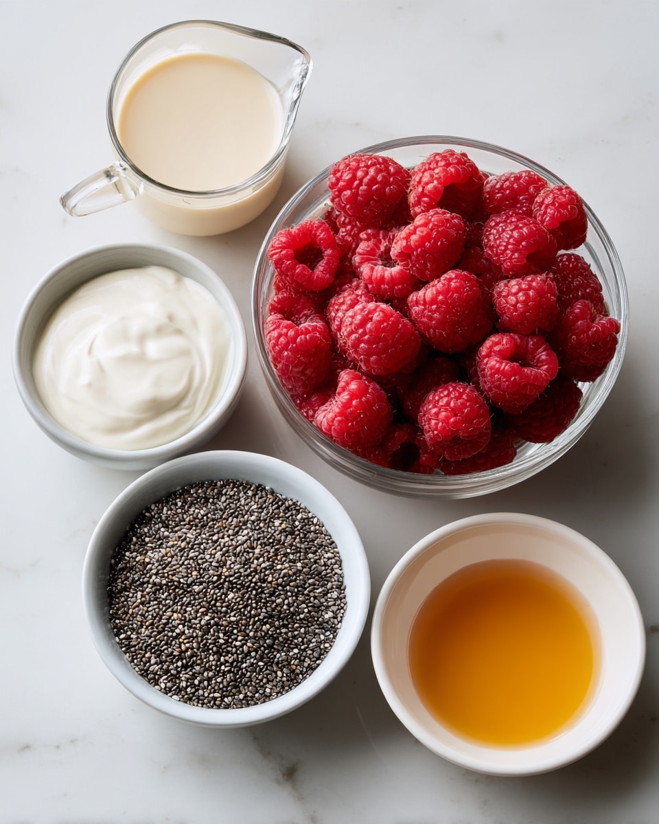 The image shows five clear glass containers arranged on a white marbled surface. In the top left, a small measuring pitcher holds a creamy beige liquid, next to it on the right is a medium bowl filled with bright red raspberries that look fresh and plump. Below these, a larger bowl contains small black and grey chia seeds, evenly spread out. To the right of the chia seeds, a small white bowl is filled with thick, white yogurt with a smooth texture. On the far right side of the image, a small white bowl holds a smooth amber-colored liquid, softly reflecting light. The photo taken with an iphone --ar 4:5 --v 7